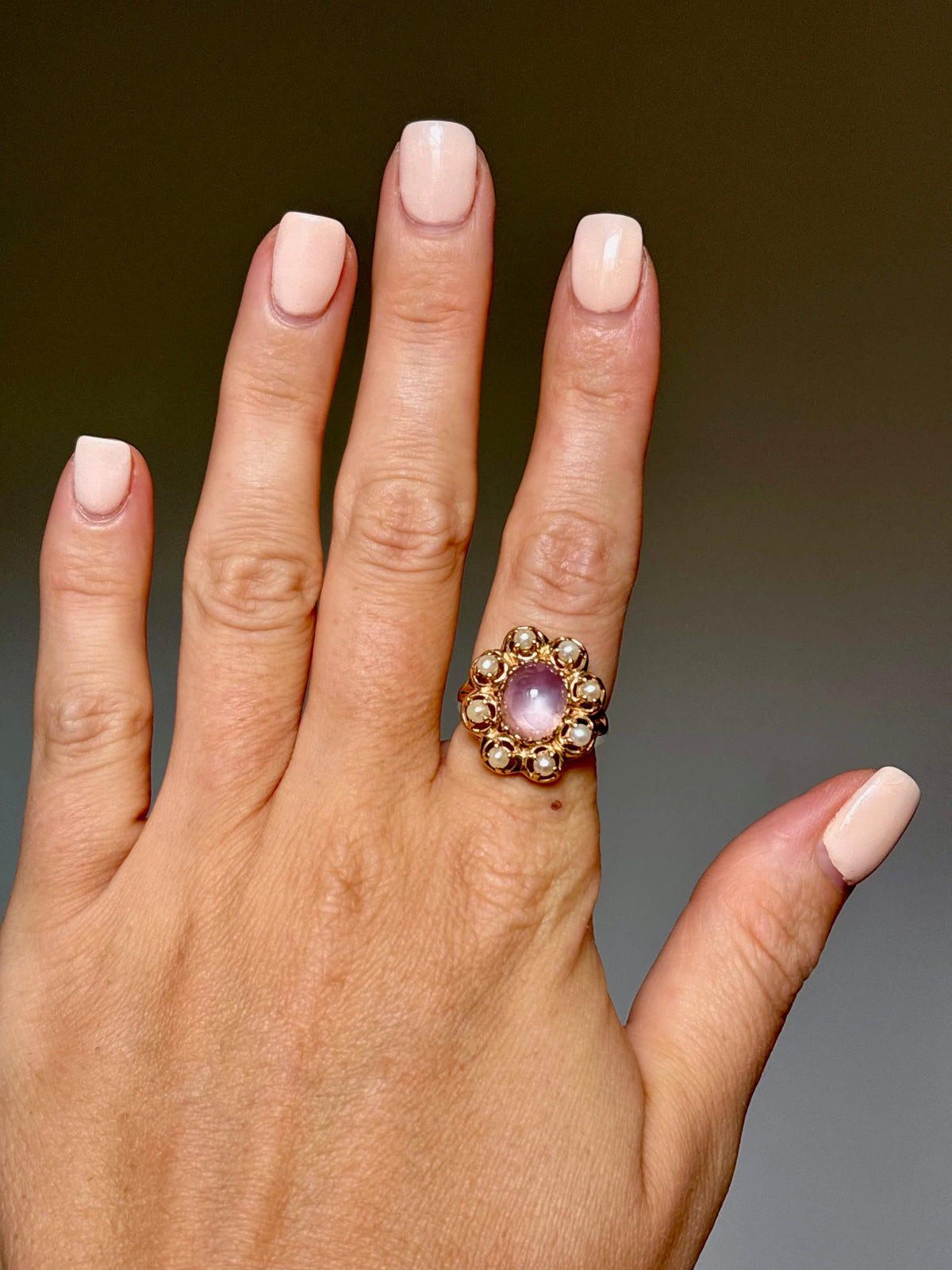pink stone ring on hand, front view